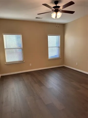 a bathroom with a granite countertop sink a toilet and shower