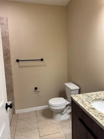 an empty room with wooden floor fan and window