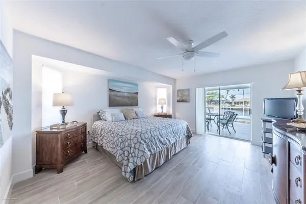 a bedroom with a bed and large windows