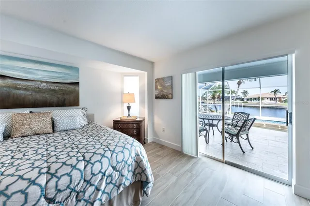 a view of a living room with furniture and floor to ceiling window