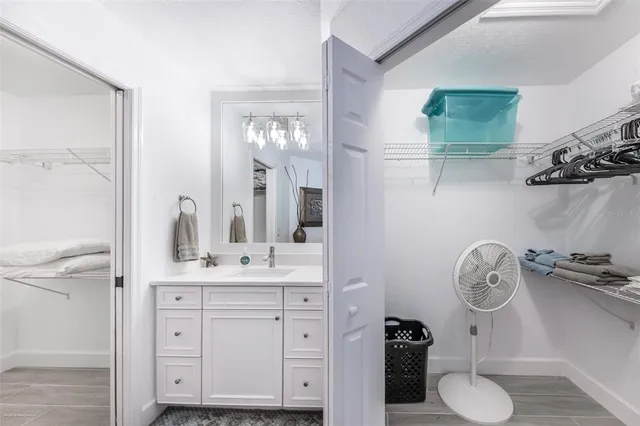 a spacious bathroom with a shower sink and mirror