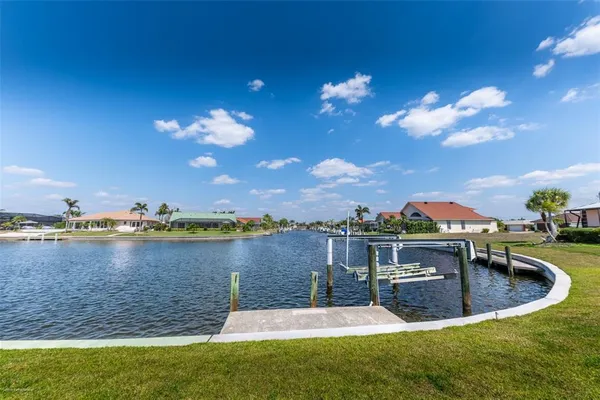 a view of a lake with houses in the background