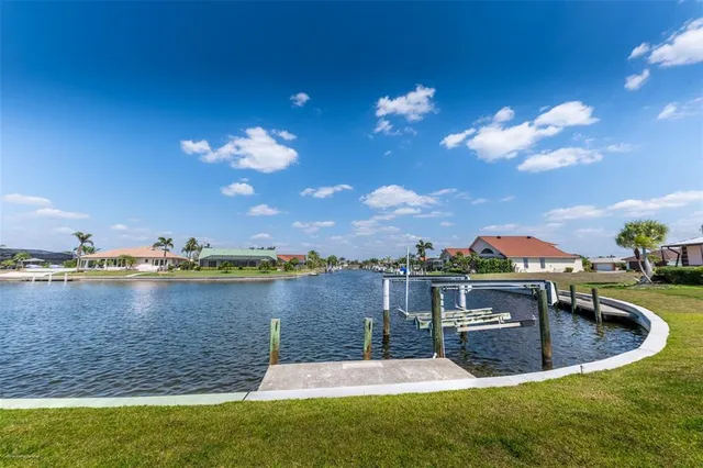 a view of a lake with houses in the background