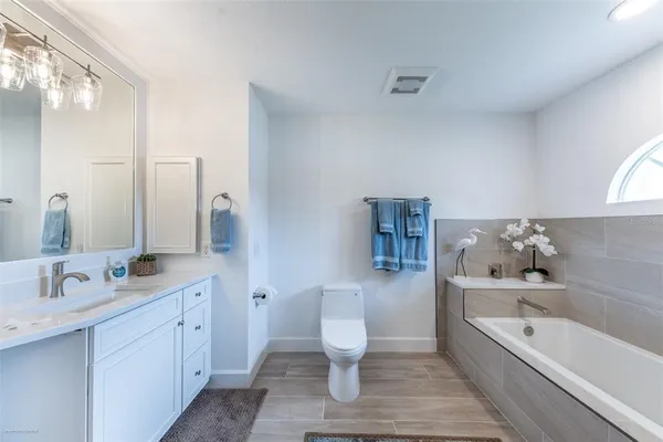 a large kitchen with stainless steel appliances granite countertop a stove granite counter tops and a view of living room