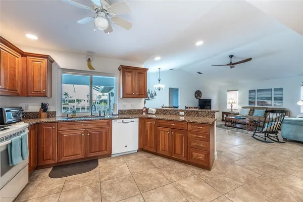 a kitchen with granite countertop a sink and cabinets