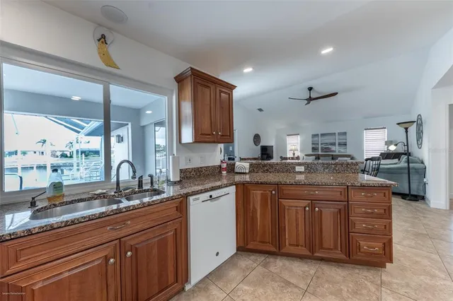 a kitchen with granite countertop a wooden cabinets and a sink