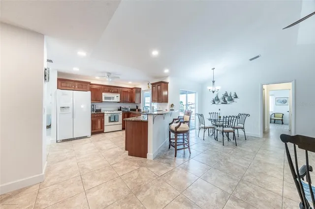a spacious bathroom with a granite countertop sink a toilet a mirror and shower