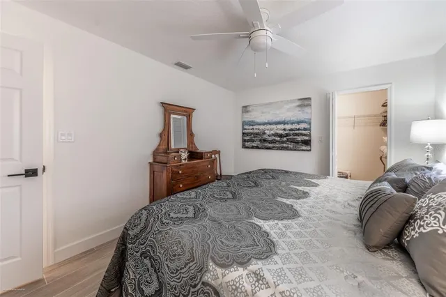 a bedroom with a bed and a chair