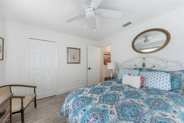 a view of a big room with windows chandelier and wooden floor