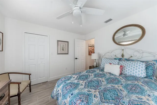 a view of a big room with windows chandelier and wooden floor