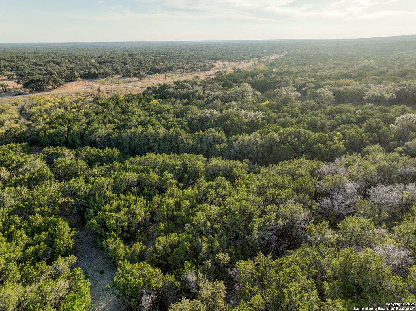 Lot 179 Valley Oaks Ranch Hondo, TX 78861 - Photo 26 of 28 an aerial view of residential houses with outdoor space and trees