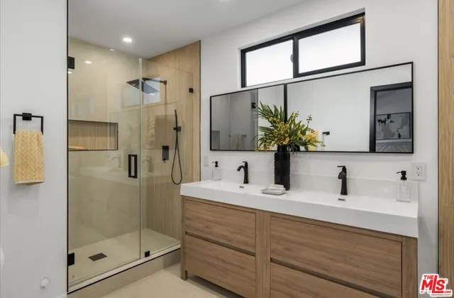 a bathroom with a shower sink and mirror