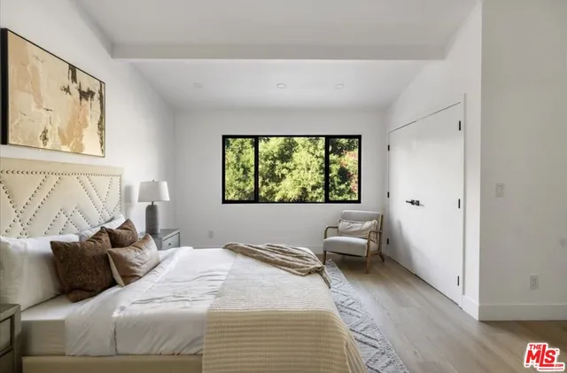 a bedroom with a large bed and a window