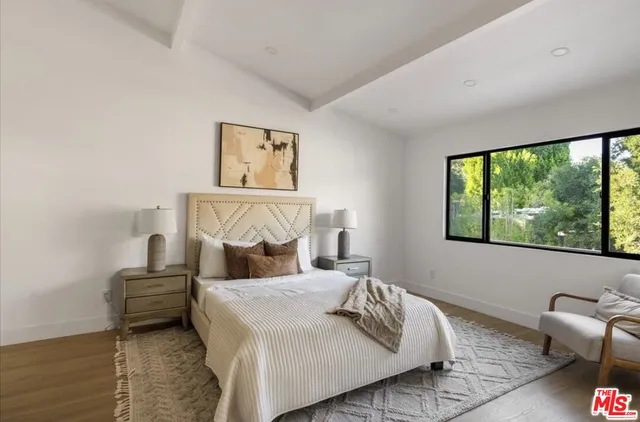 a bedroom with a bed and window