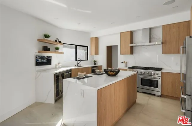 a kitchen with stainless steel appliances granite countertop a stove a sink and a refrigerator