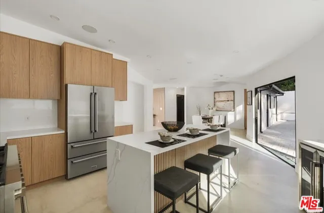 a kitchen with stainless steel appliances a refrigerator and a stove top oven