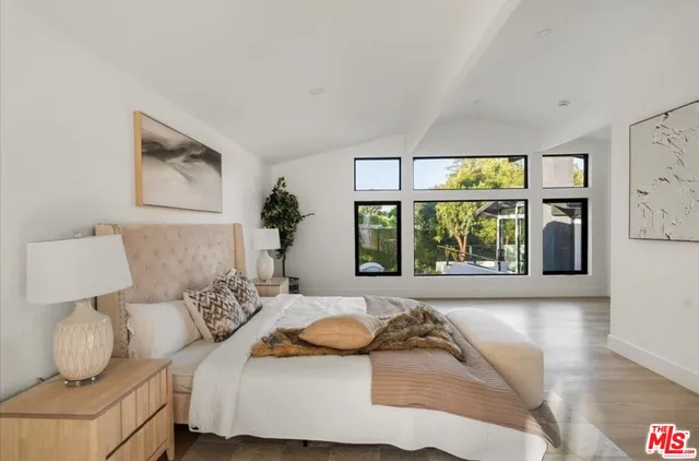 a bedroom with bed and window