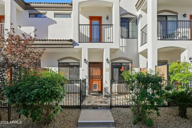 a front view of a multi story residential apartment building with a yard