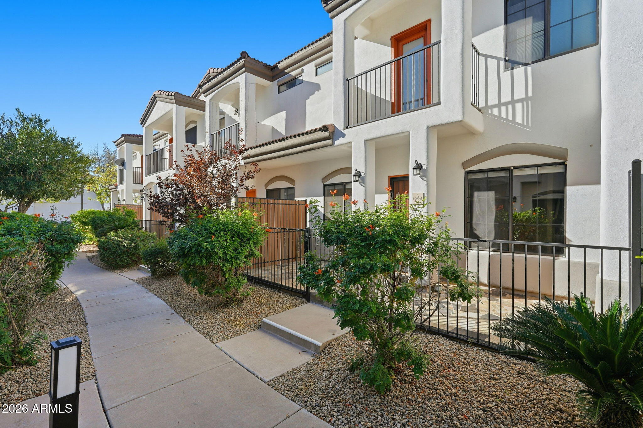 3150 East Beardsley Road, Unit 1064 Phoenix, AZ 85050 - Photo 2 of 30 a front view of a multi story residential apartment building with a yard