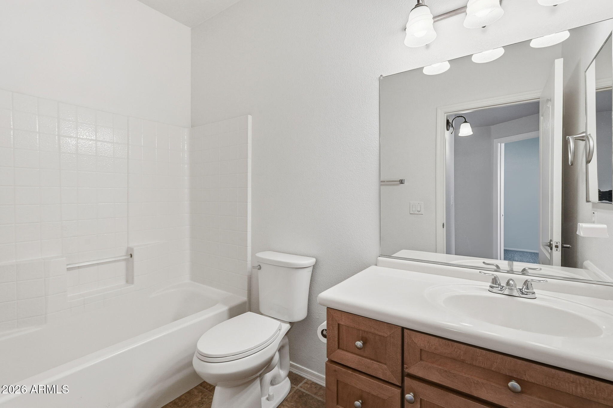 3150 East Beardsley Road, Unit 1064 Phoenix, AZ 85050 - Photo 24 of 30 a bathroom with a sink a toilet and a mirror