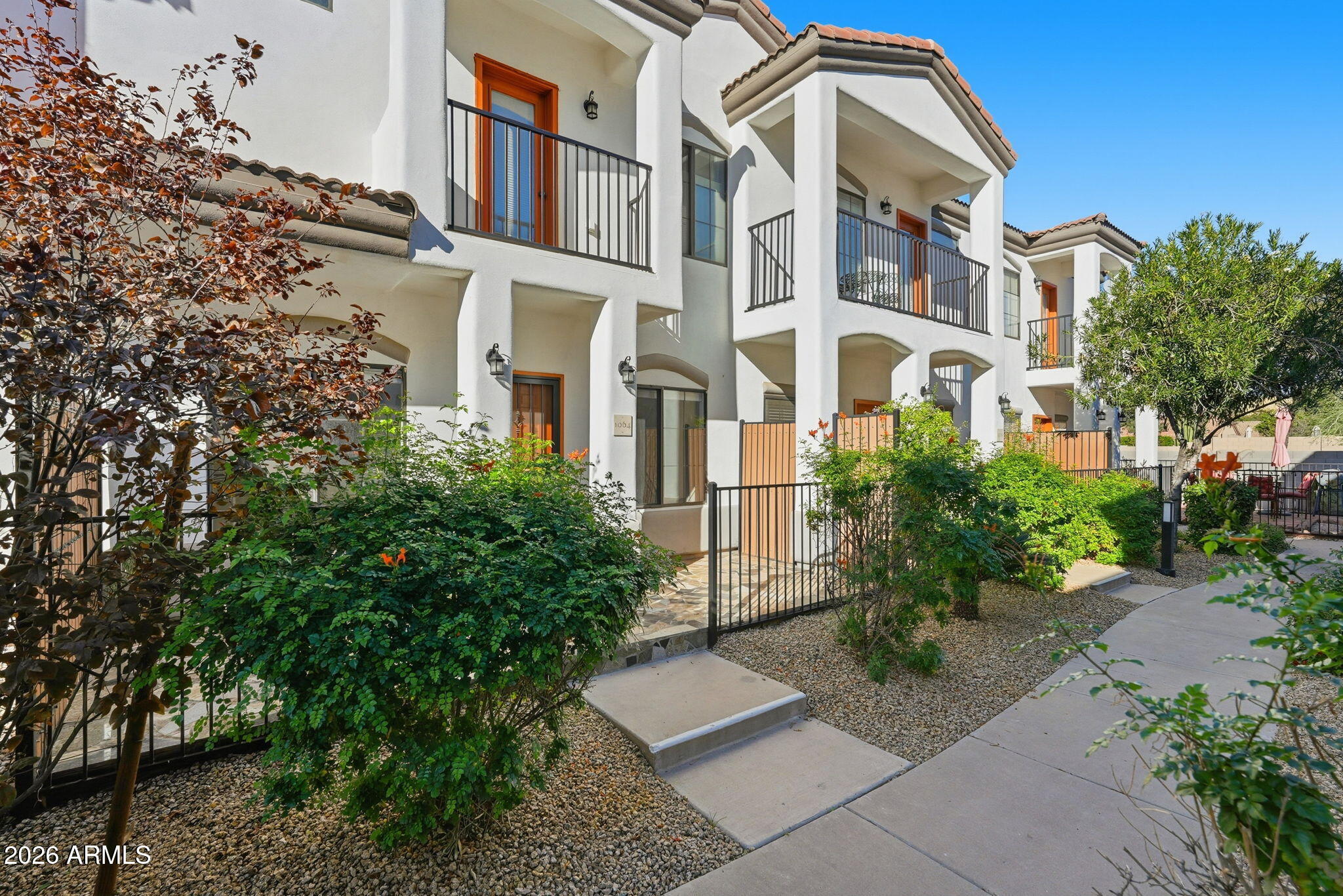 3150 East Beardsley Road, Unit 1064 Phoenix, AZ 85050 - Photo 3 of 30 a front view of a multi story residential apartment building with yard and parking space