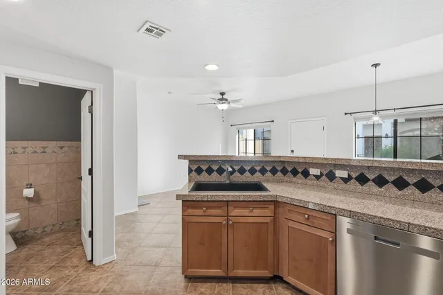 a kitchen with stainless steel appliances granite countertop a refrigerator and a stove