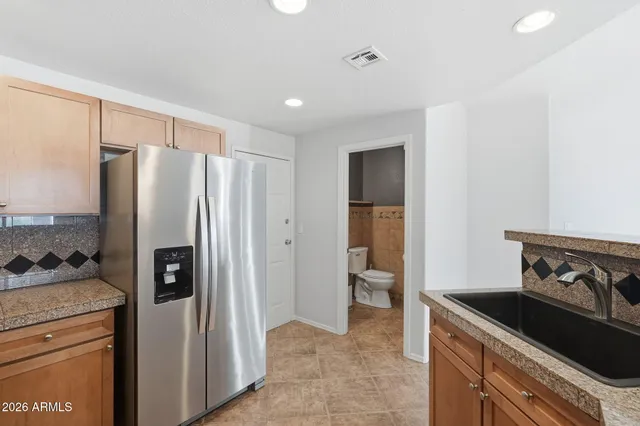 a kitchen with stainless steel appliances granite countertop a refrigerator stove and microwave