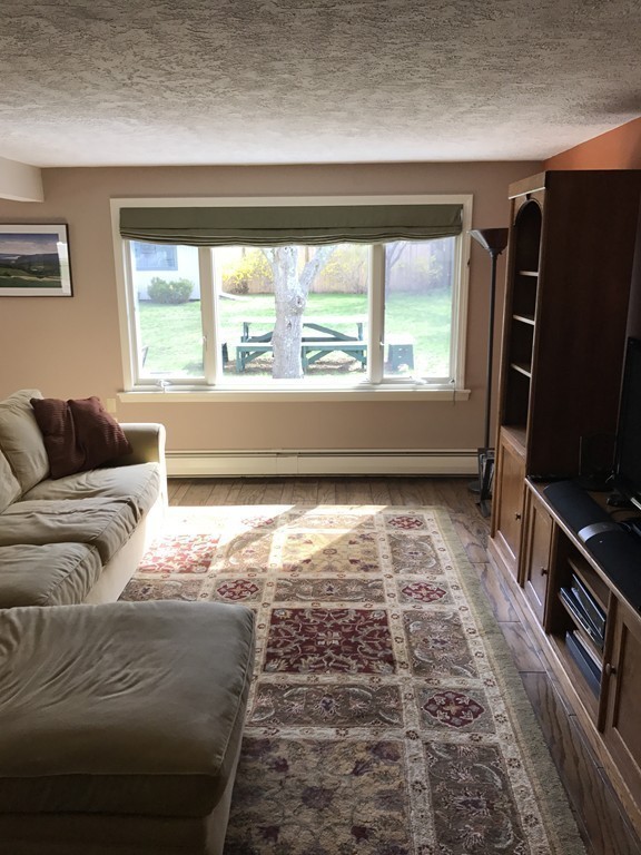 31 Elmfield Road Framingham, MA 01701 - Photo 13 of 25 a living room with a large window with a flat screen tv