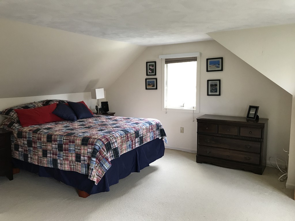31 Elmfield Road Framingham, MA 01701 - Photo 15 of 25 a bedroom with a bed lamp and a window