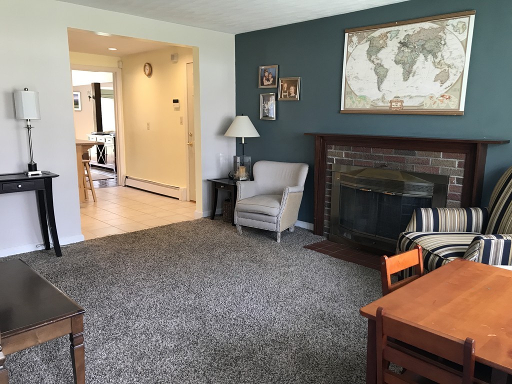31 Elmfield Road Framingham, MA 01701 - Photo 4 of 25 a living room with furniture a fireplace and wooden floor