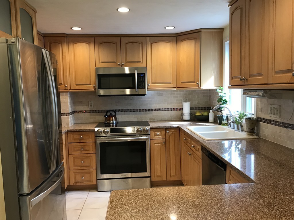 31 Elmfield Road Framingham, MA 01701 - Photo 8 of 25 a kitchen with stainless steel appliances granite countertop a stove a sink and a refrigerator