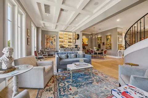 a living room with furniture and a potted plant