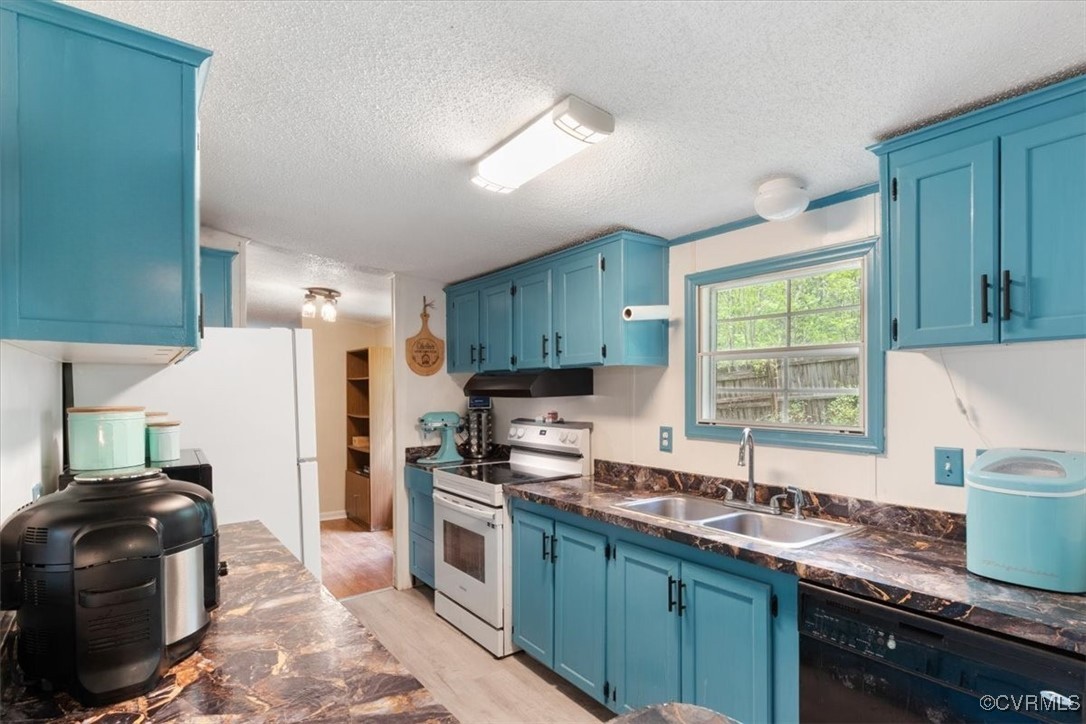 10340 Swift Road Partlow, VA 22534 - Photo 11 of 25 a kitchen with granite countertop a stove a sink and a refrigerator