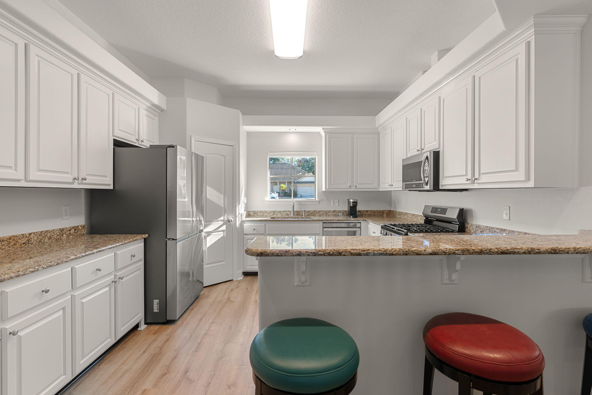 207 Pinque Coat Court Crestview, FL 32536 - Photo 18 of 47 a kitchen with stainless steel appliances granite countertop a sink a stove and refrigerator