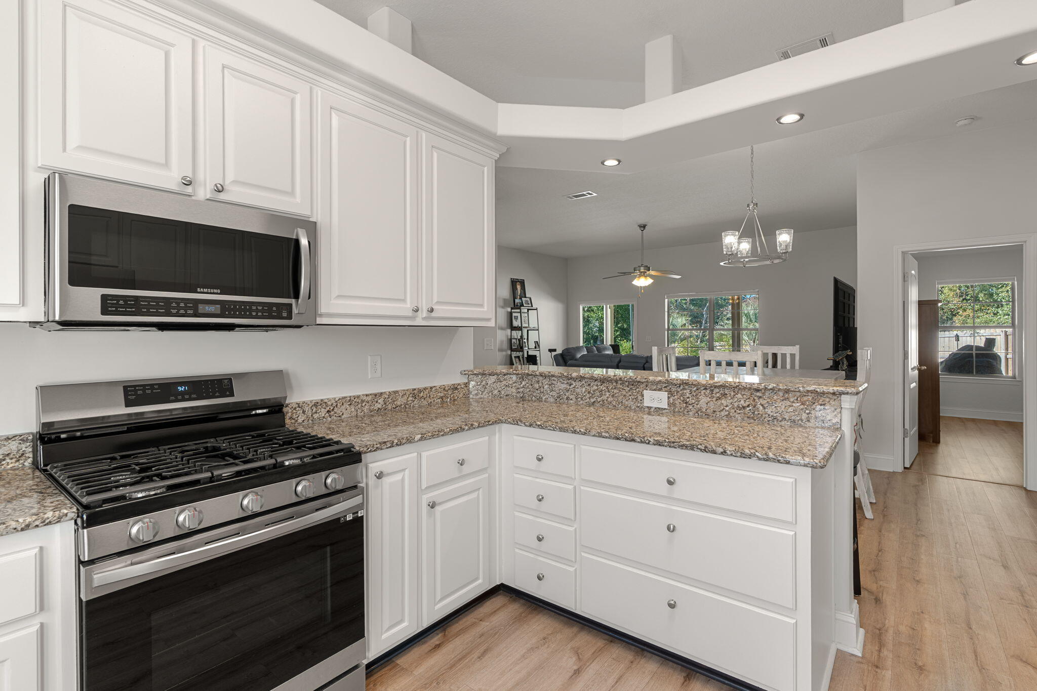 207 Pinque Coat Court Crestview, FL 32536 - Photo 19 of 47 a kitchen with granite countertop a stove and white cabinets