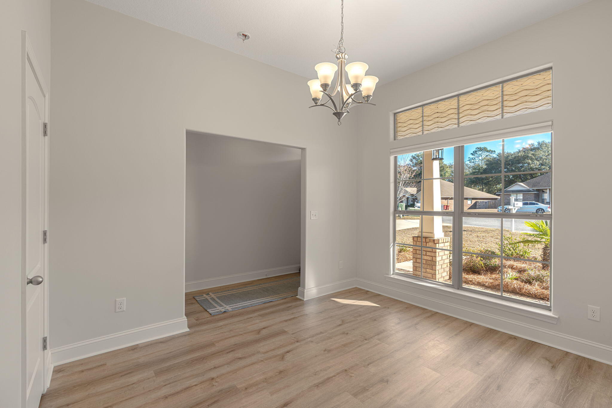 207 Pinque Coat Court Crestview, FL 32536 - Photo 23 of 47 a view of an empty room with wooden floor and a window