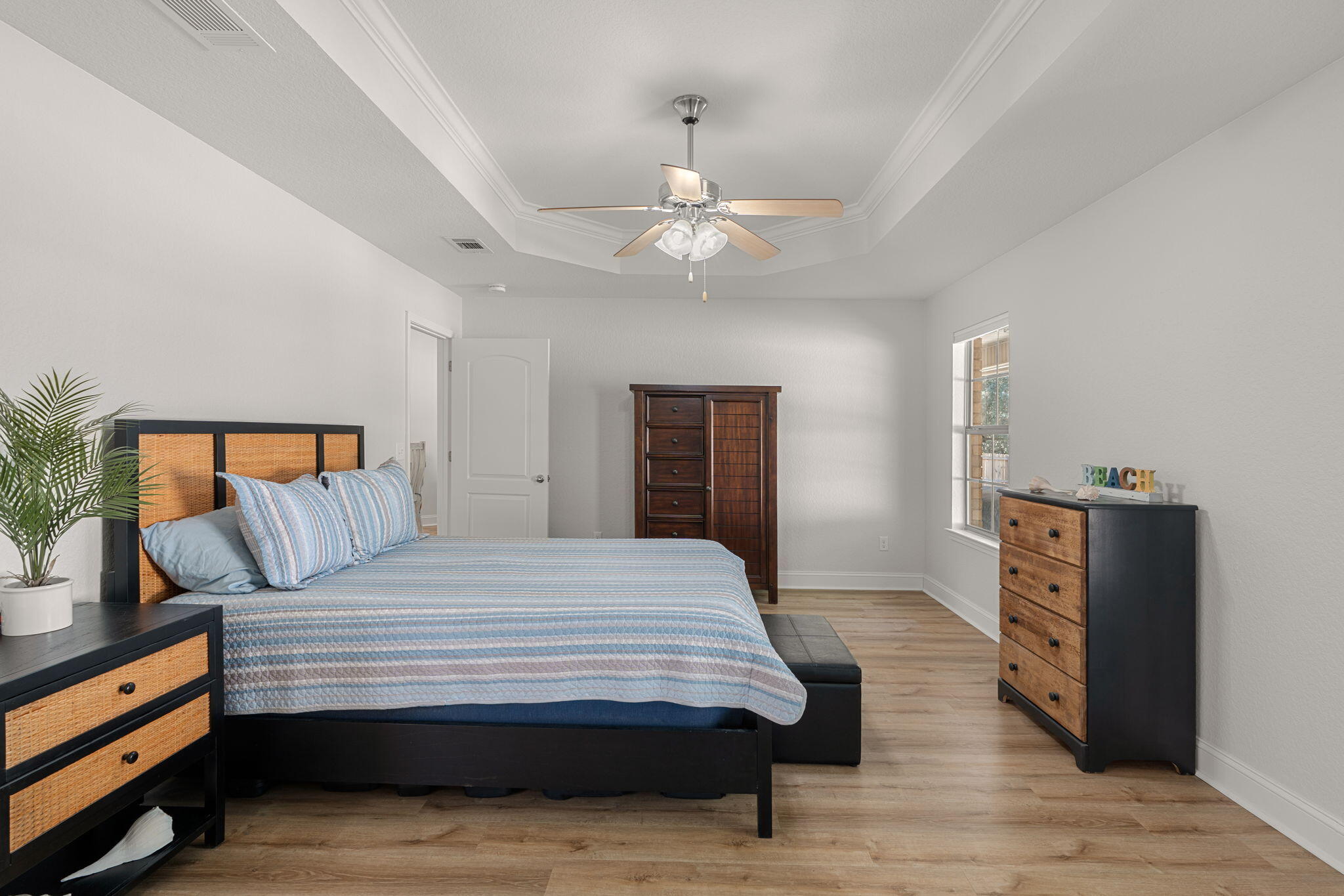 207 Pinque Coat Court Crestview, FL 32536 - Photo 24 of 47 a bedroom with a bed and wooden floor