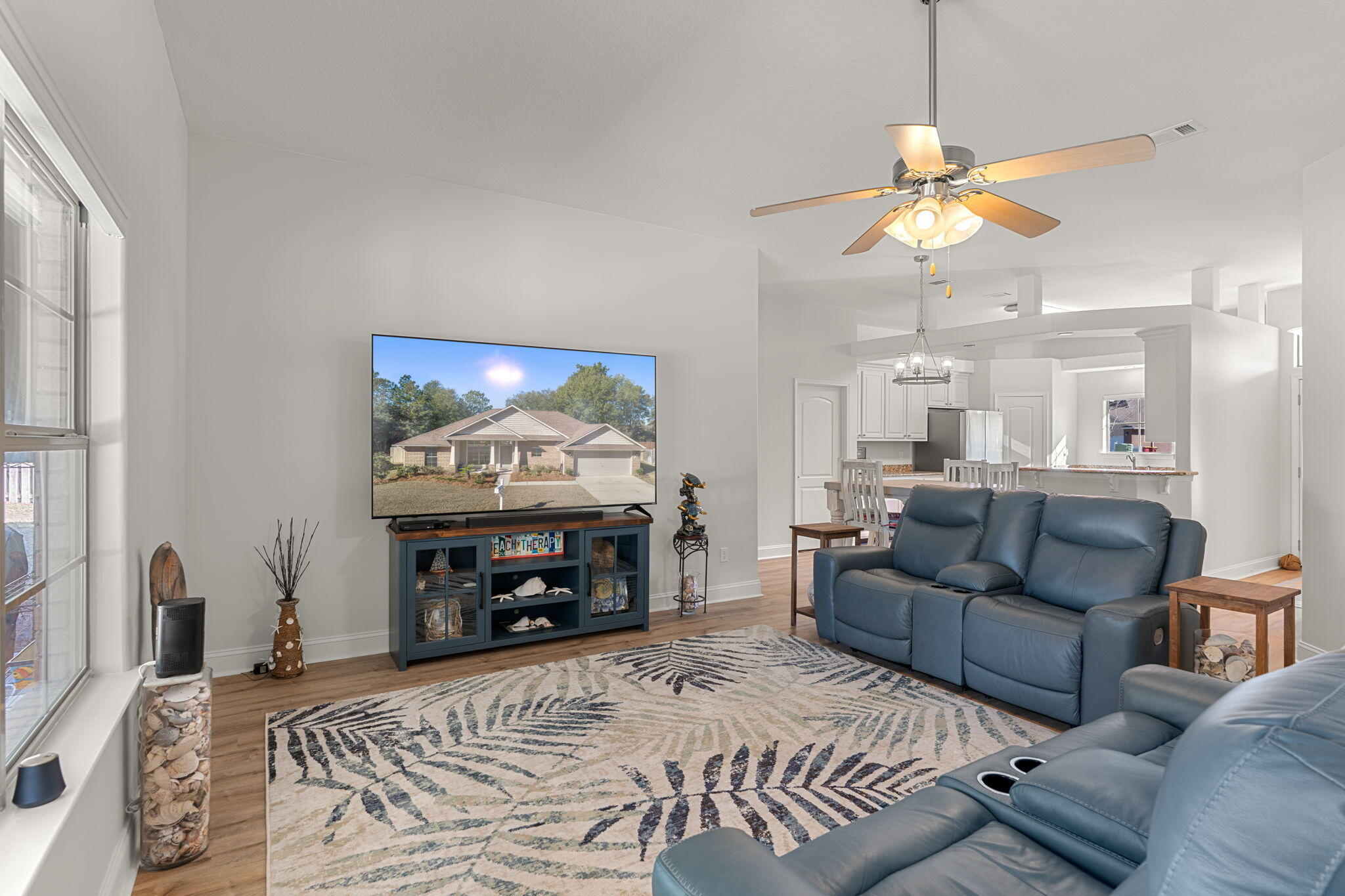 207 Pinque Coat Court Crestview, FL 32536 - Photo 4 of 47 a living room with furniture a fireplace and a flat screen tv