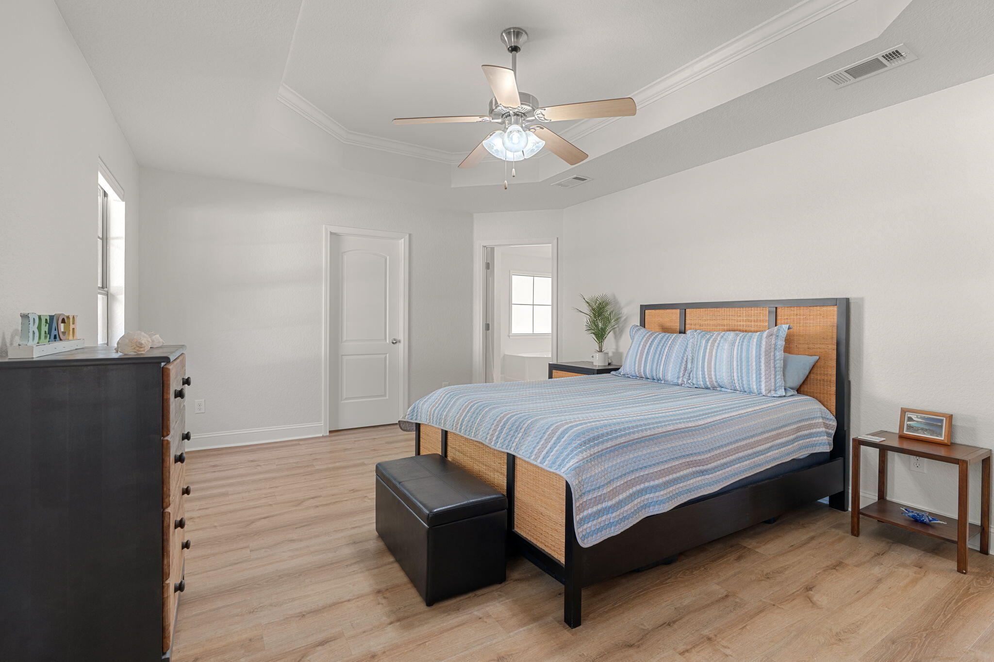207 Pinque Coat Court Crestview, FL 32536 - Photo 6 of 47 a spacious bedroom with a bed and a chandelier