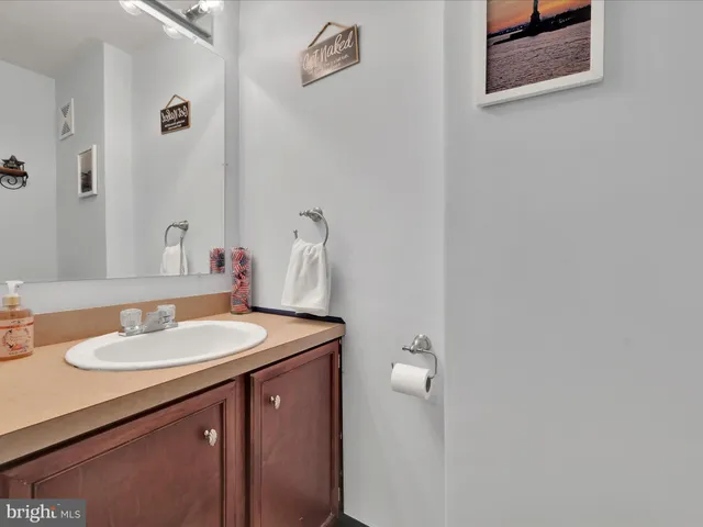 a bathroom with a sink vanity and a mirror