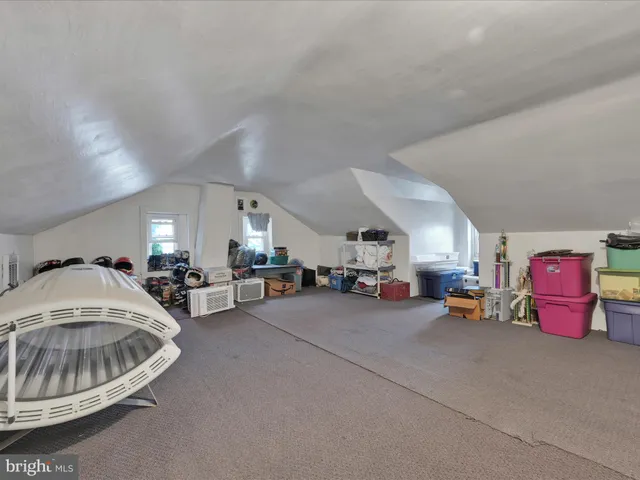 a view of a livingroom with furniture and cars