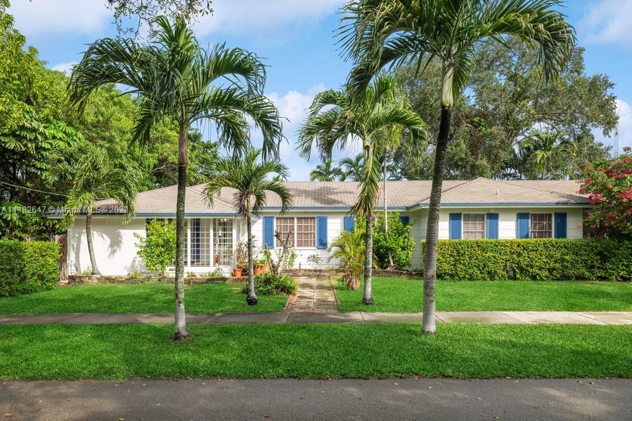 3531 Southwest 13th Street Miami, FL 33135 - Photo 1 of 25 a front view of a house with a garden and yard