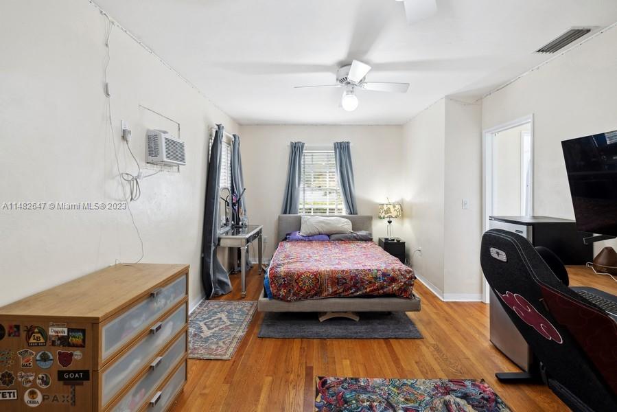 3531 Southwest 13th Street Miami, FL 33135 - Photo 15 of 25 a bed room with a bed and a flat tv screen on a dresser