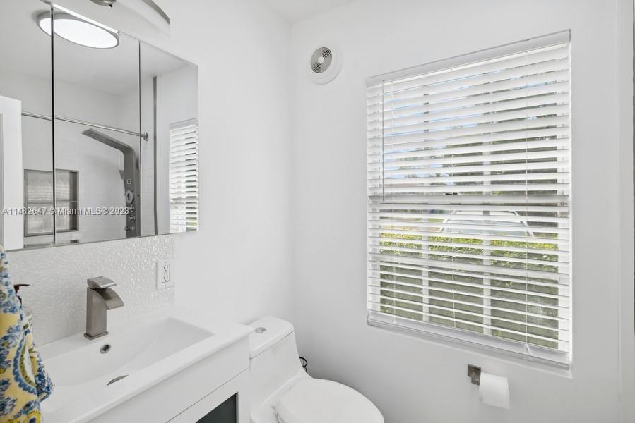 3531 Southwest 13th Street Miami, FL 33135 - Photo 16 of 25 a bathroom with a sink a toilet and a mirror