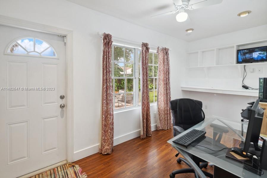 3531 Southwest 13th Street Miami, FL 33135 - Photo 17 of 25 a view of a workspace with furniture and a window