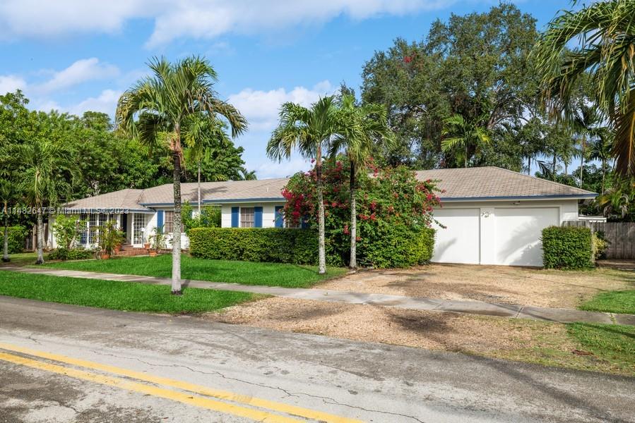 3531 Southwest 13th Street Miami, FL 33135 - Photo 2 of 25 a front view of a house with a yard and potted plants