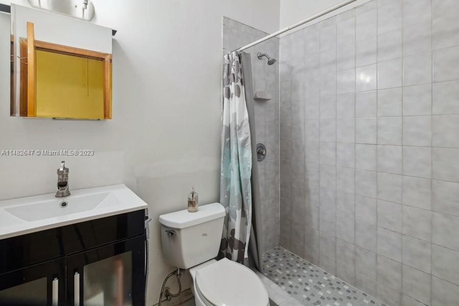 3531 Southwest 13th Street Miami, FL 33135 - Photo 24 of 25 a bathroom with a sink toilet and shower