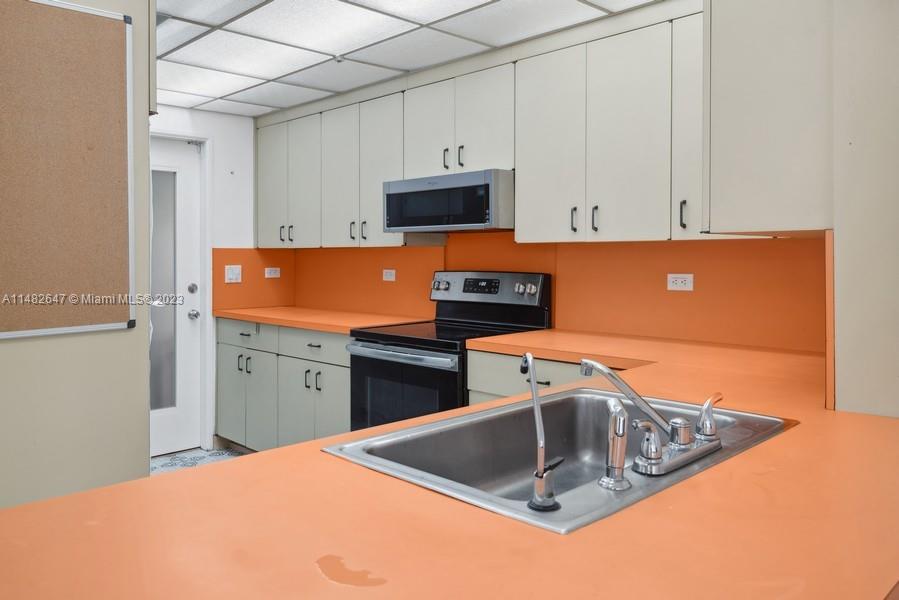 3531 Southwest 13th Street Miami, FL 33135 - Photo 7 of 25 a kitchen with a sink cabinets and stainless steel appliances