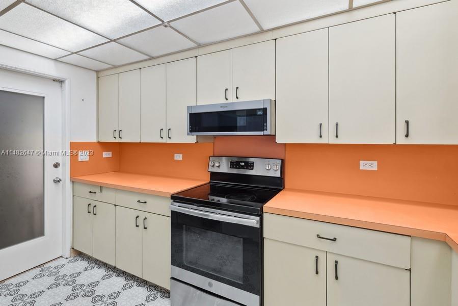3531 Southwest 13th Street Miami, FL 33135 - Photo 8 of 25 a kitchen with a sink and a stove top oven