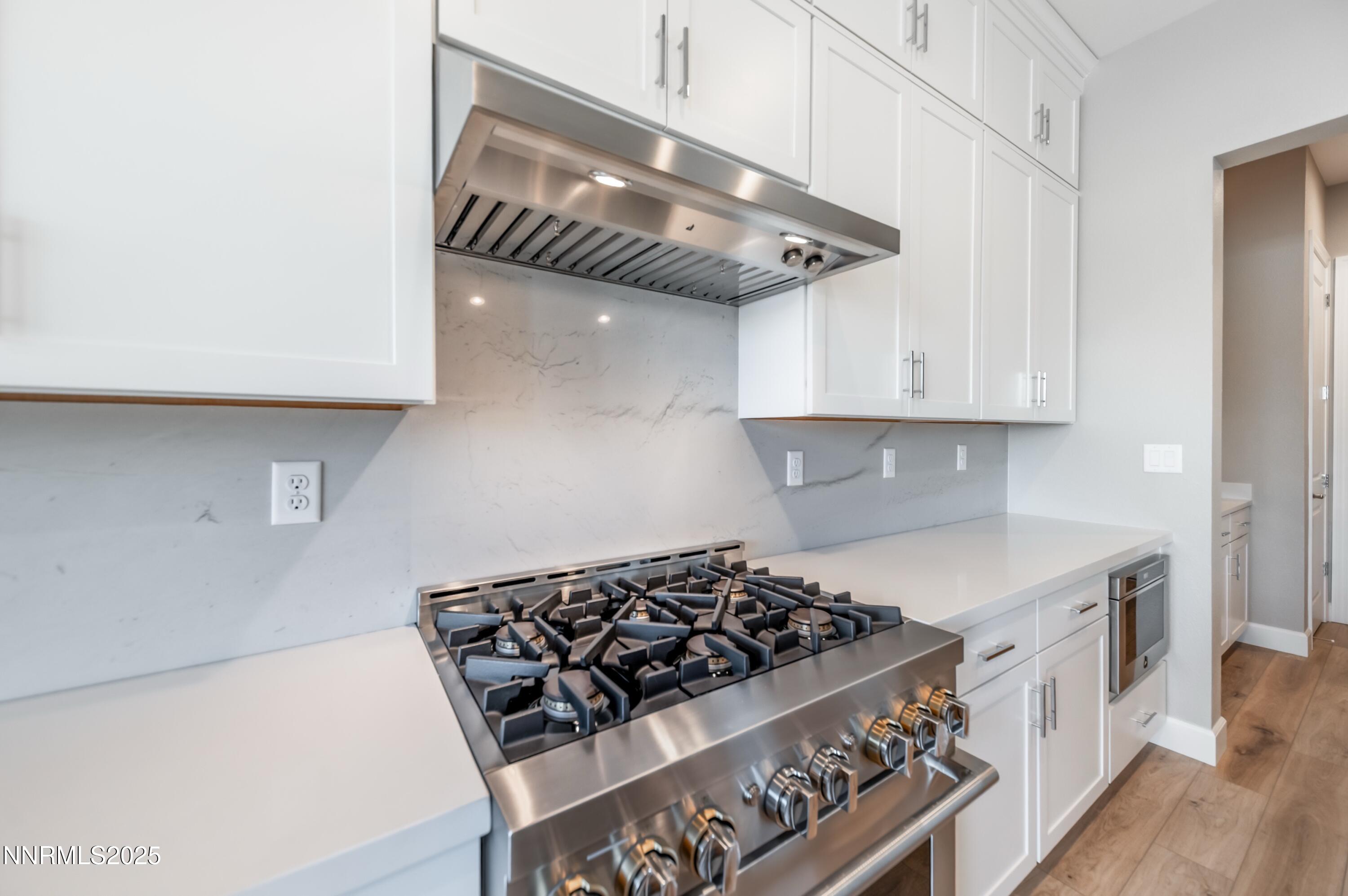 1517 Golf Club Drive Reno, NV 89519 - Photo 13 of 49 a kitchen with stainless steel appliances granite countertop a stove and a white cabinets